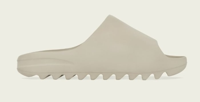 Side view of tan adidas Yeezy slide.